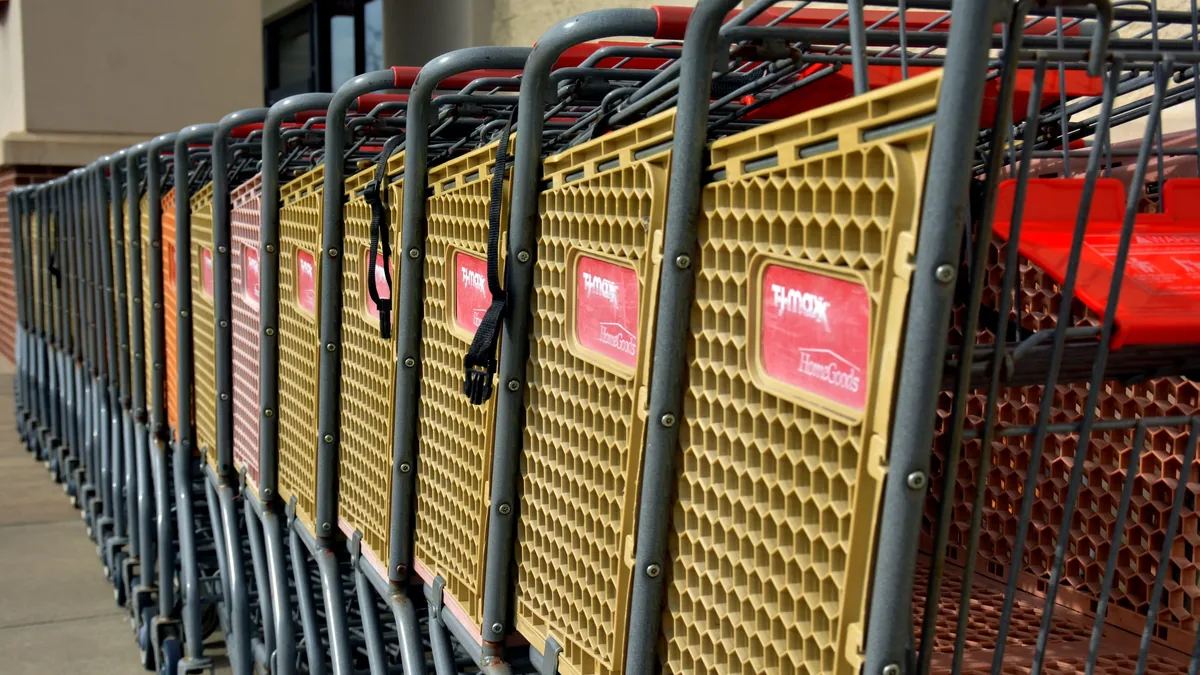 A row of shopping carts lined up outside a store.