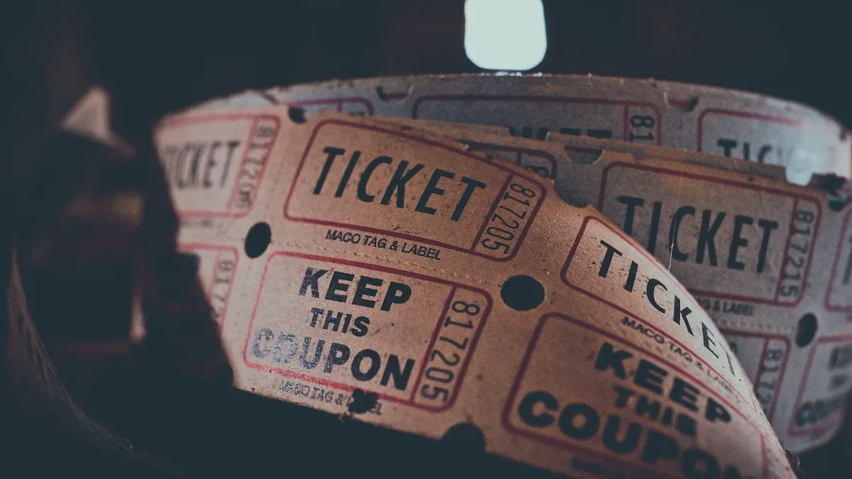 A roll of raffle tickets with the words "TICKET" and "KEEP THIS COUPON" printed on them.