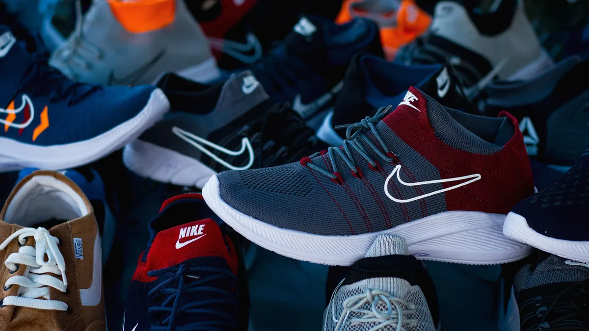 A collection of Nike shoes, with one shoe prominently displayed in the foreground and several others visible in the background.